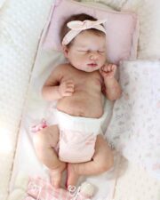 Baby Loulou realistic reborn baby doll with brownish rooted hair being gently bathed like a real newborn