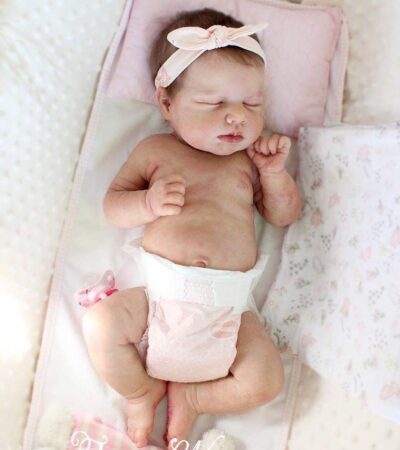 Baby Loulou realistic reborn baby doll with brownish rooted hair being gently bathed like a real newborn