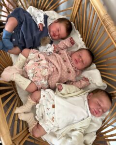 Reborn doll collector holding a full body silicone reborn baby by Joanna Kazmierzak Pietka showing lifelike newborn details and realistic skin texture